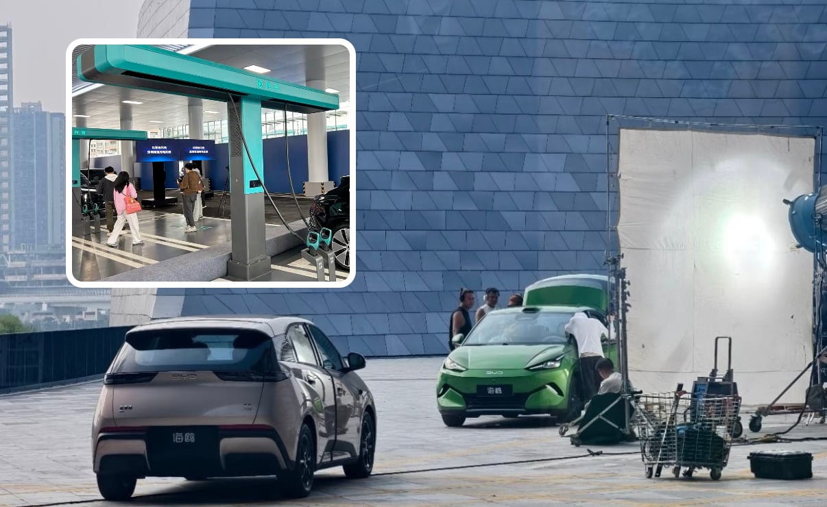 Camouflaged second-gen BYD Seagull parked in front of a Flash Charge station mockup